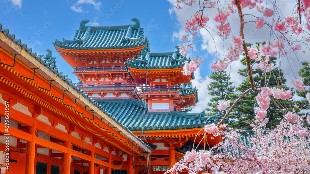 Fototapeta premium Kyoto, Japan - April 2 2023: Heian Jingu Garden is a garden with a variety of plants, ponds and buildings and weeping cherry trees, making it's one of the best cherry blossom spots in Kyoto