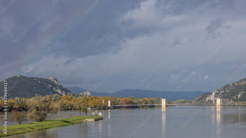 Beginning of a rainbow over the Pont du Robinet in Donzere, France