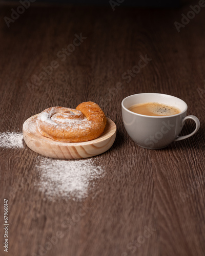 Breakfast with ensaimada and cup of coffee photo