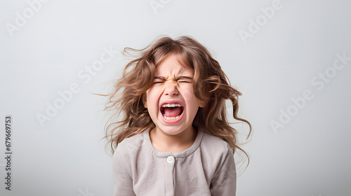 A girl screaming on light background