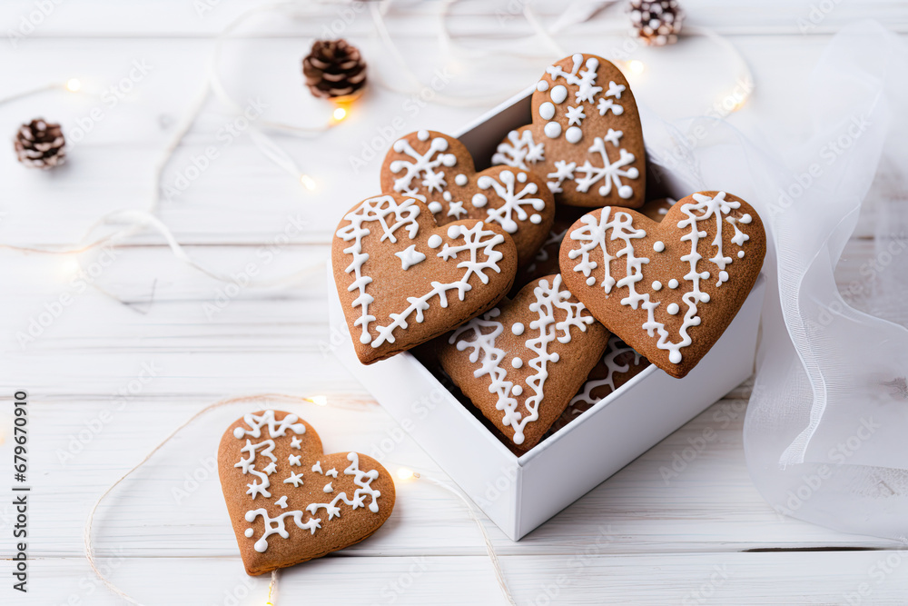 Open box with heart  shaped ginger cookies on wooden background
