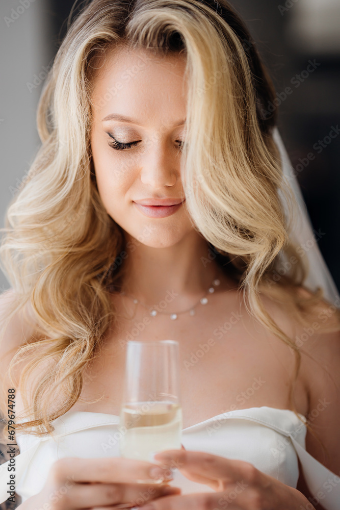 Portrait of a beautiful young blonde woman with a glass of champagne. Portrait of a beautiful young blonde woman with a glass of champagne.
