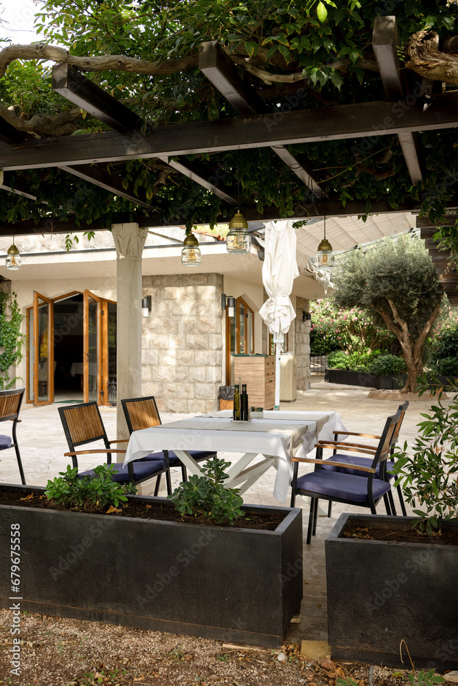 A set table and chairs on the summer veranda of a cafes without people A set table and chairs on the summer veranda of a cafes without people