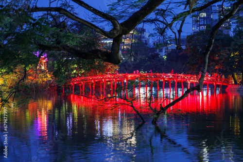 The Huc Bridge illuminated at night in Hanoi, Vietnam photo