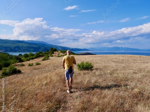 Man hiking on Lin peninsula  Albania  Lake Ohrid in the background.