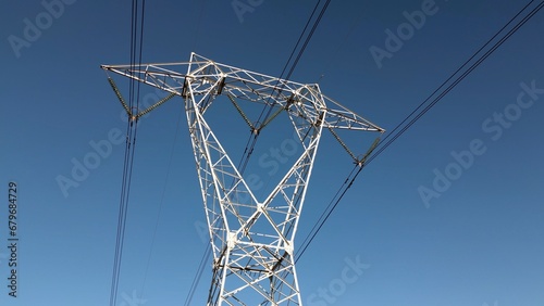 High voltage pylon for the transport of electricity and houses with solar panels close to Milan  in Lombardy Italy Europe - green revolution, Save the planet and climate change - increase energy cost 