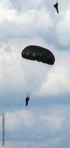 Victory Show. Leicester, UK. Renacted parachute jump with round military style parchutes. 