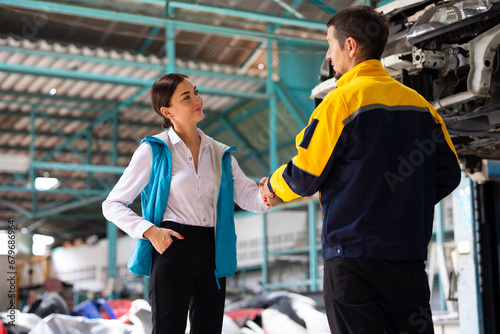 Insurance claim Inspector Inspect damage car caused by car crash on the road with customer. Car insurance agent examining car in garage. Motor insurance. Successful businessmen handshaking good deal