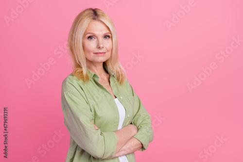 Photo of successful confident retired lady wear stylish clothes arms folded demonstrate empty space isolated on pink color background
