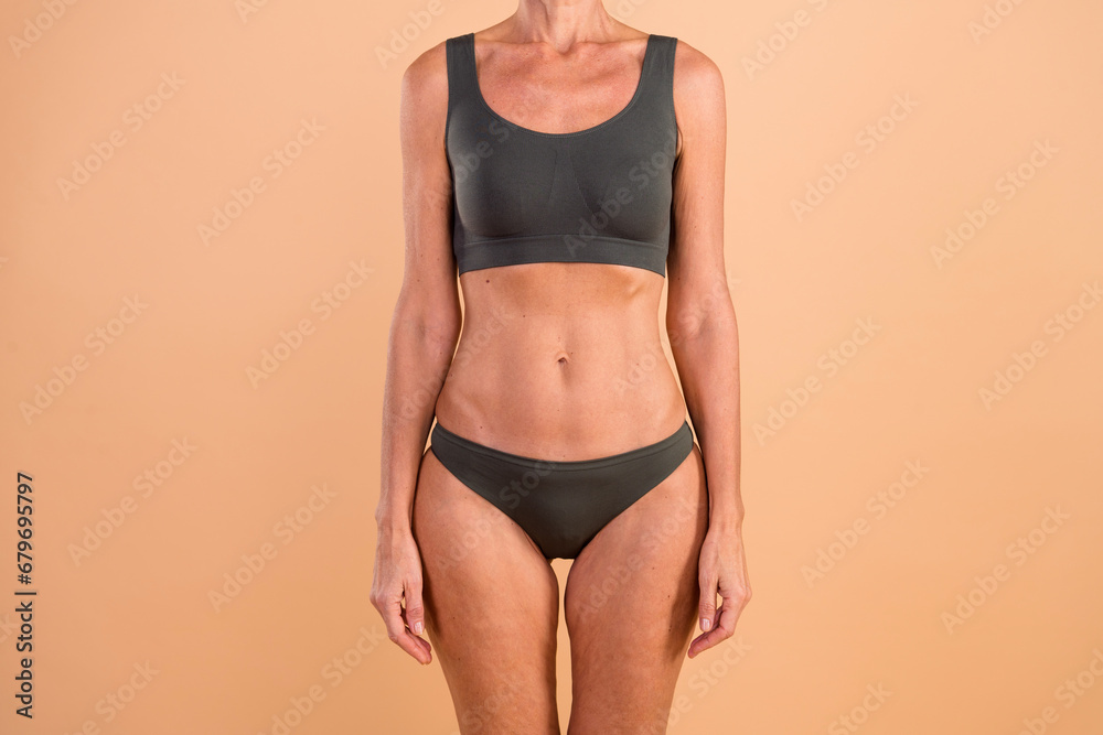 Cropped photo of senior lady in grey top underwear prepare for morning yoga training isolated pastel color background Cropped photo of senior lady in grey top underwear prepare for morning yoga training isolated pastel color background