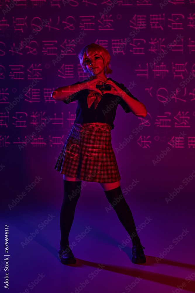 stylish anime woman in school uniform showing heart sign on neon purple backdrop with hieroglyphs stylish anime woman in school uniform showing heart sign on neon purple backdrop with hieroglyphs
