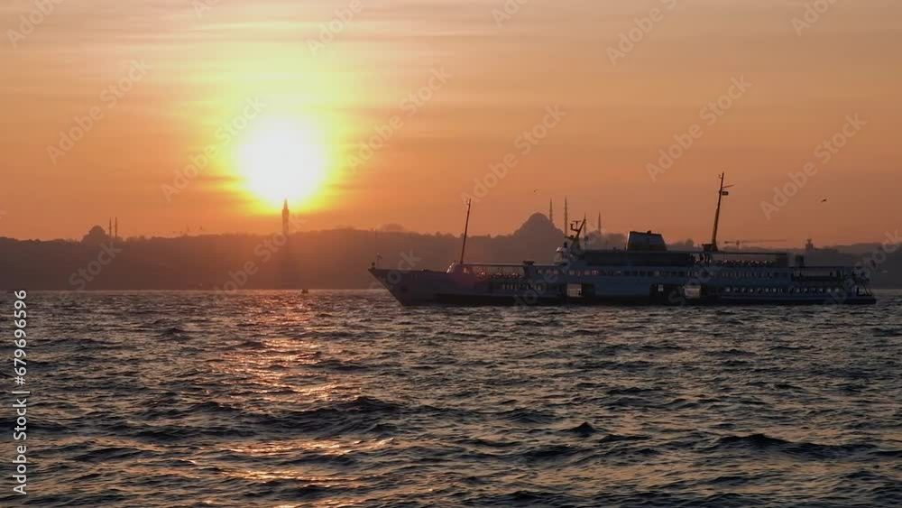 Sunset in Istanbul. Bosphorus with ferry boat. Sun behind silhouettes of Mosque Sunset in Istanbul. Bosphorus with ferry boat. Sun behind silhouettes of Mosque