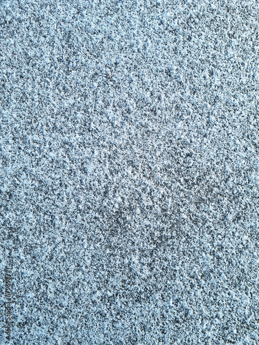 The texture of the snow on the ground or on the asphalt in winter. Winter background for design