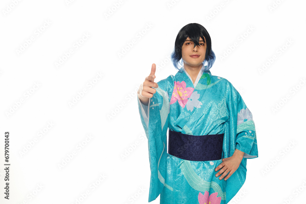 young creative man in blue kimono and wig pointing with finger at camera on white, cosplay culture young creative man in blue kimono and wig pointing with finger at camera on white, cosplay culture