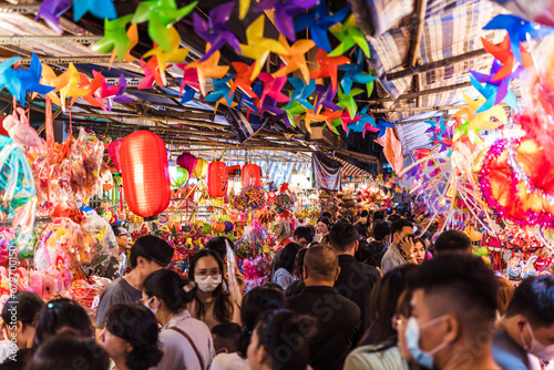 People visit and buy colorful traditional lanterns hanging on Luong Nhu Hoc Street in Vietnam