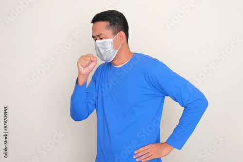 Adult Asian man wearing medical mask got cough photo