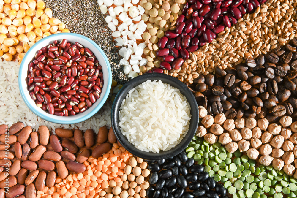 Naklejka premium Bowl with raw white rices and beans on various seeds grain