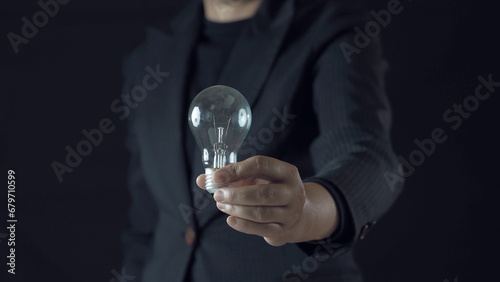 business. businessman hold lightbulb in that has cog and idea.