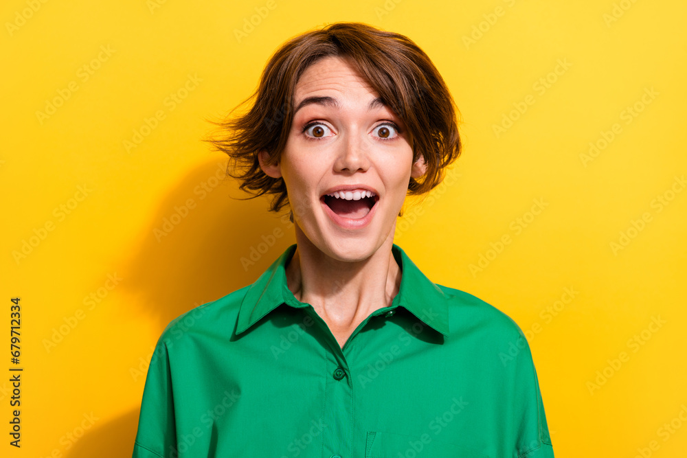 Closeup portrait of attractive young business lady look open mouth excited news wearing green shirt isolated yellow color background Closeup portrait of attractive young business lady look open mouth excited news wearing green shirt isolated yellow color background