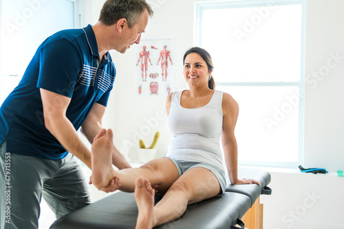 Modern rehabilitation physiotherapy man at work with woman client