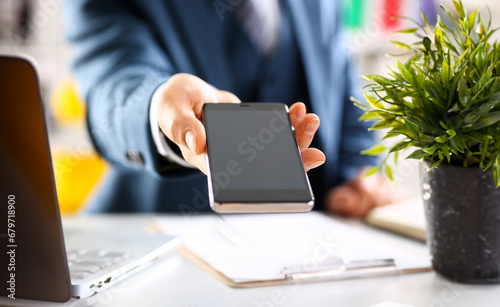 Male arm in suit show in camera phone display screen closeup. Read news mania send sms chat addict use electronic bank modern lifestyle job plan colleague share blog tweet web application search