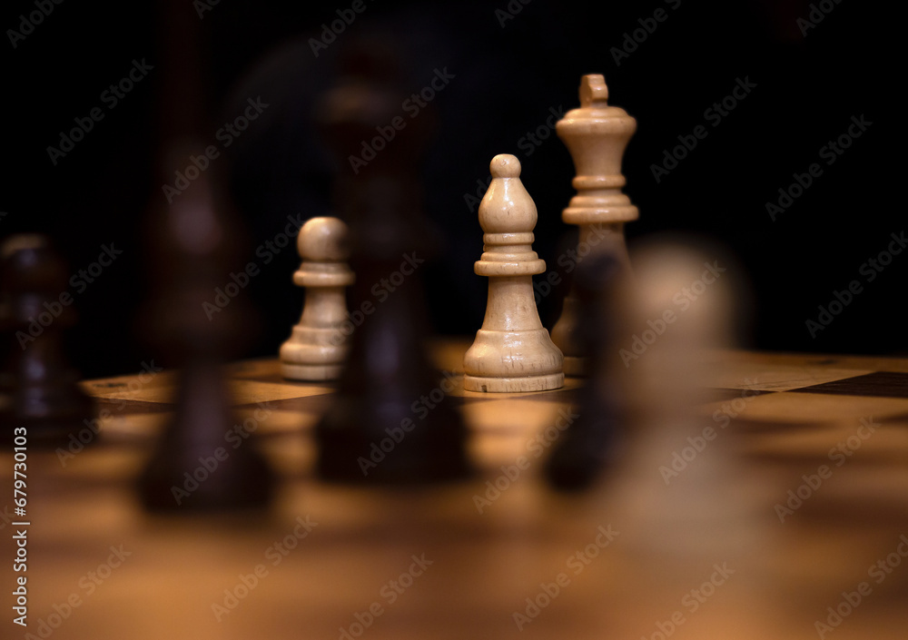 Wooden Chess pieces on a chessboard. Logic game. Strategy for victory. Wooden Chess pieces on a chessboard. Logic game. Strategy for victory.