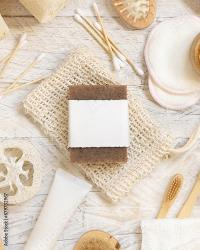 Soap bar with blank label on soap saver bag near hygiene Items top view, mockup