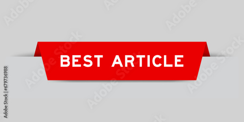 Red color inserted label with word best article on gray background