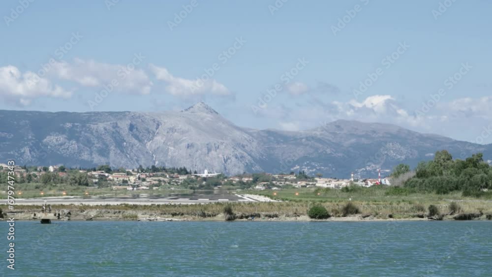 Large passenger plane take off from runaway on airport in Kerkira city on Corfu island in Greece, slow motion Large passenger plane take off from runaway on airport in Kerkira city on Corfu island in Greece, slow motion