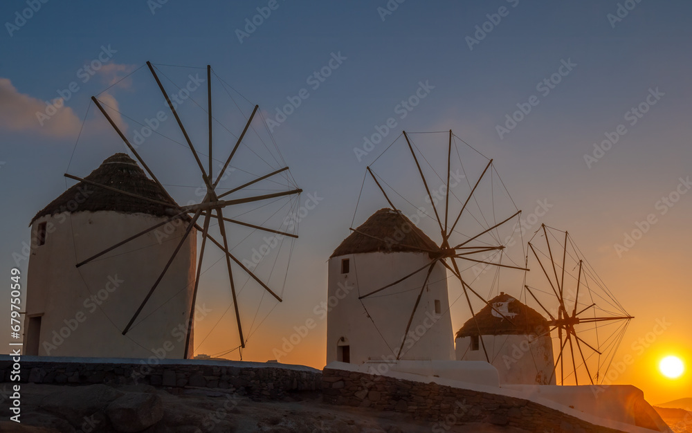 Sunset behind the iconic Mykonos windmills Mykonos island, Cyclades Islands, Aegean Sea, Greece,