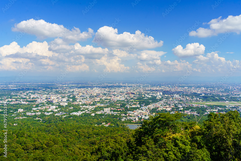 view in the mountains with road cityscape over the city building hotel, shopping mall,temple and houses air cloudy sky background with white cloud.