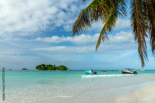 Seychelles scenic landscape with Chauve Souris island from Anse Volbert beach in Praslin island photo
