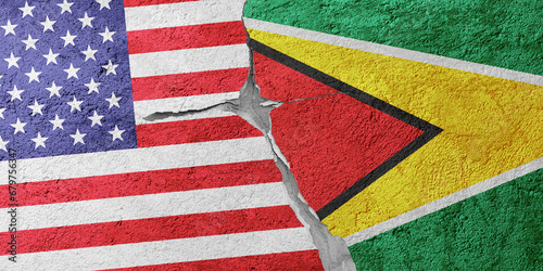 USA and Guyana flags on a stone wall with a crack, illustration of the concept of a global crisis in political and economic relations