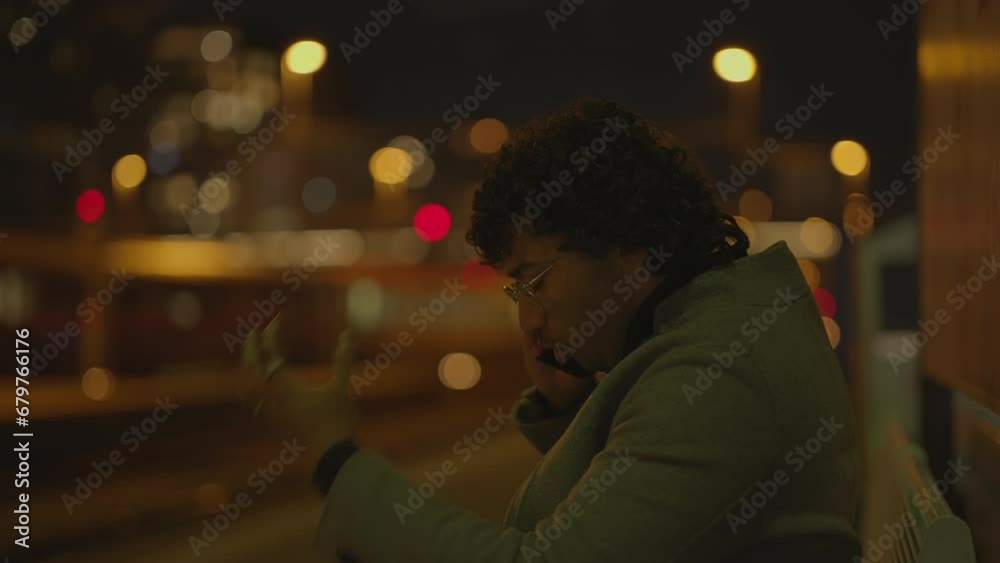 Young Man With Black Curly Hair Waiting Lonely at Train Station at Night Young Man With Black Curly Hair Waiting Lonely at Train Station at Night