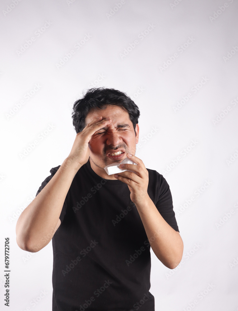 Photograph of person with headache, sneezing, holding toilet paper. Concept of health and diseases. Photograph of person with headache, sneezing, holding toilet paper. Concept of health and diseases.