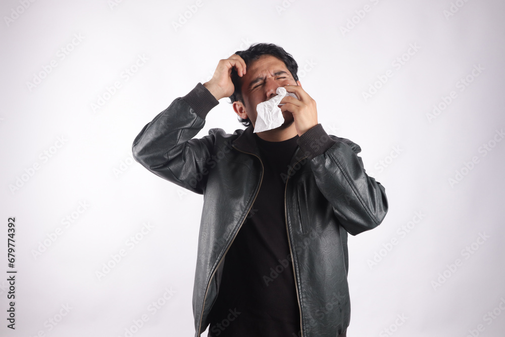 Photograph of person with headache, sneezing, holding toilet paper. Concept of health and diseases. Photograph of person with headache, sneezing, holding toilet paper. Concept of health and diseases.