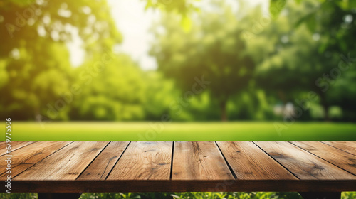 Wooden table and blurred green nature garden background.