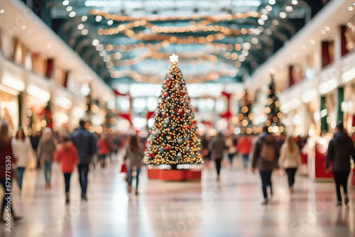 Shopping mall with stores, Christmas tree with decoration and crowd of people looking for present gifts. photo