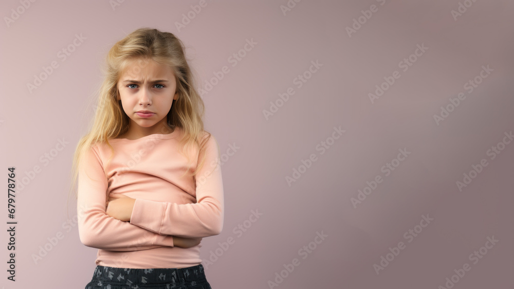 Blonde little girl wincing in pain and hand rubbing stomach Blonde little girl wincing in pain and hand rubbing stomach
