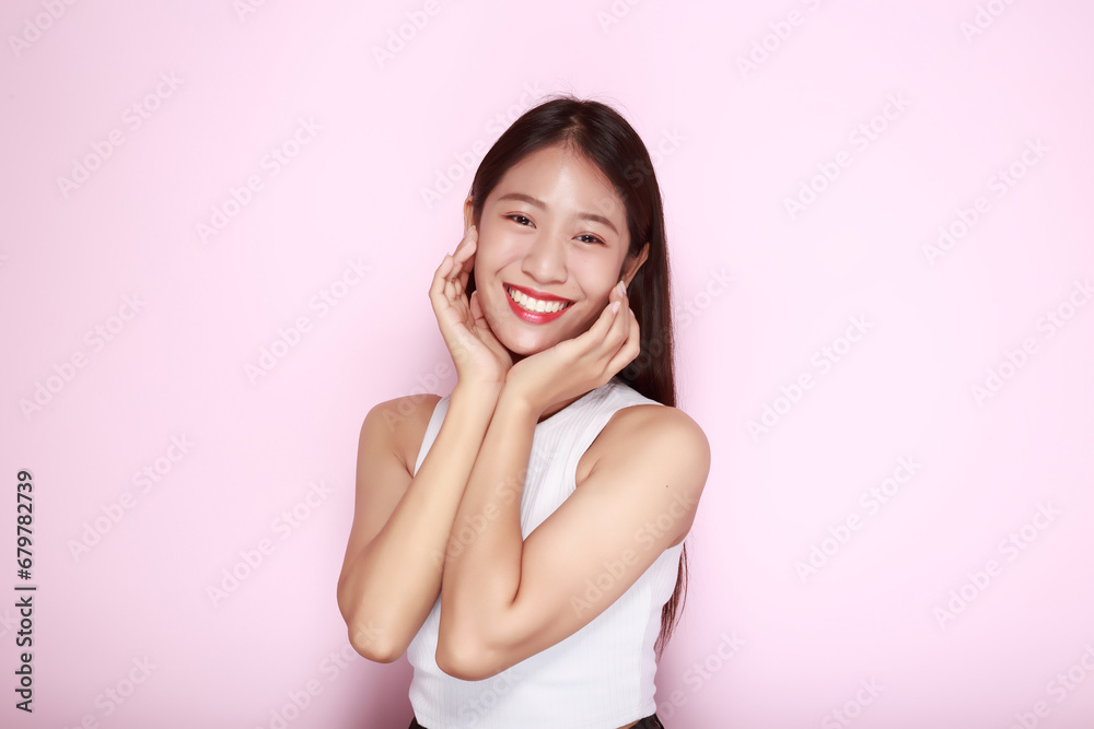 Beautiful girl smiling happily, Portrait of a beautiful young woman in a light pink background, happy and smile, posting in stand position. Beautiful girl smiling happily, Portrait of a beautiful young woman in a light pink background, happy and smile, posting in stand position.