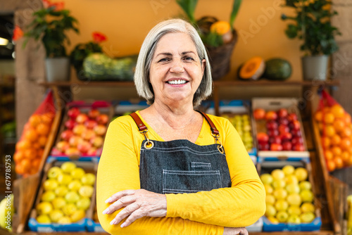 Konstfotografi Female greengrocer working at the market shop - Food retail concept