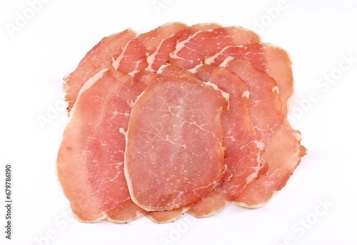 Slices of Lonzino on white background. It is a type of italian salumi  made of cured pork loin. photo