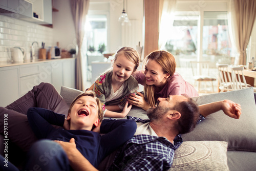 Joyful Parents Having Playtime with Children at Home