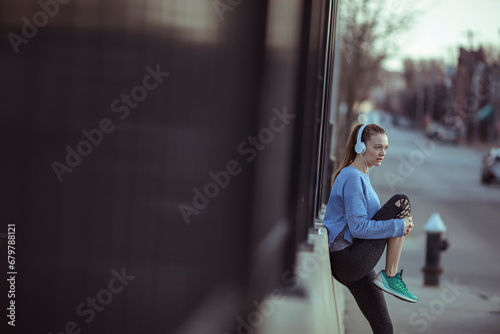 Active Woman Stretching Before a Run in Urban Environment