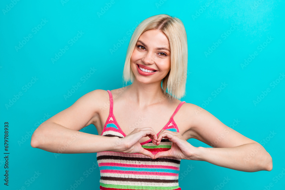 Photo portrait of pretty young girl heart showing gesture shape girlfriend wear trendy striped outfit isolated on cyan color background Photo portrait of pretty young girl heart showing gesture shape girlfriend wear trendy striped outfit isolated on cyan color background