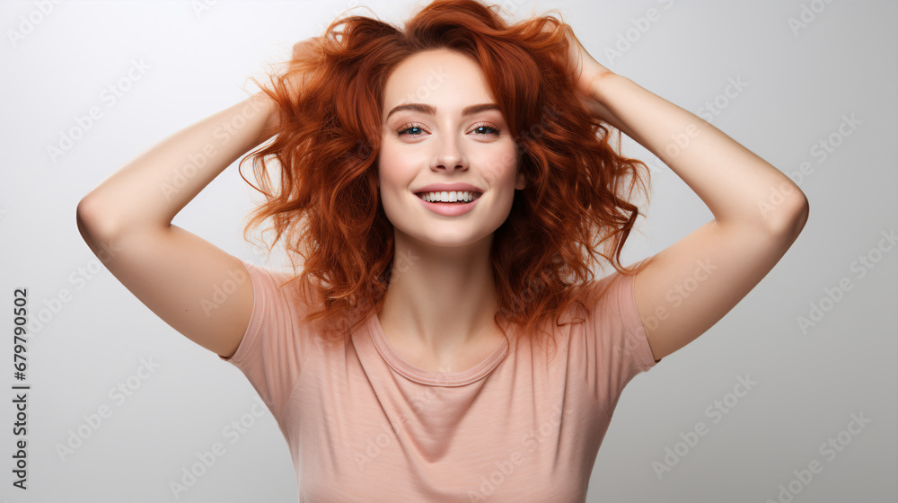 Obraz premium A ,joyful redhead joyously raising their arms and dancing, wearing a blue tee and denim, stands alone on a plain backdrop.