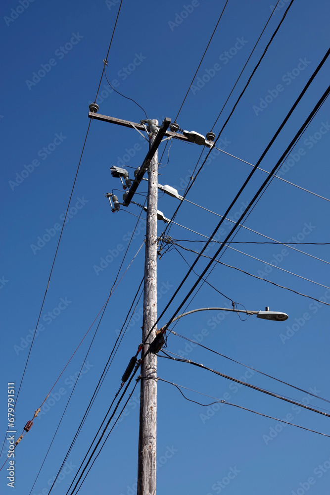 Top of an electricity pylon under blue sky Top of an electricity pylon under blue sky