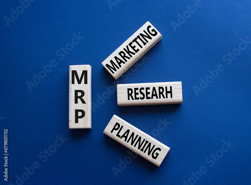 MRP - Marketing Research Planning symbol. Concept word MRP on wooden cubes. Beautiful deep blue background. Business and MRP concept. Copy space.