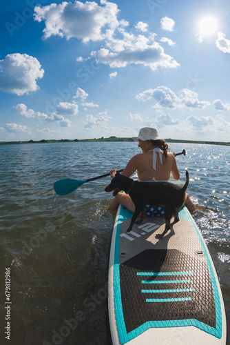 happy woman with dog on supboard photo