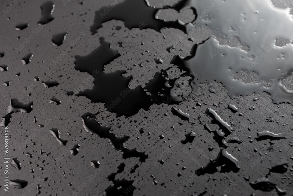abstract background of wet black clean painted surface - close-up with selective focus